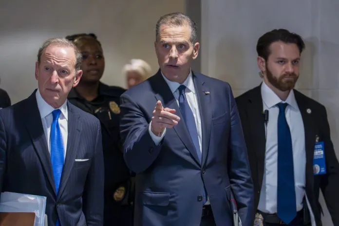 Abe Lowell walking next to Hunter Biden and security