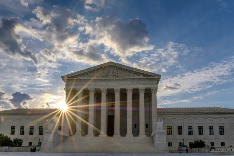 FILE - The sun flares in the camera lens as it rises behind the U.S. Supreme Court building in Washington, June 25, 2017. (AP Photo/J. David Ake, File)