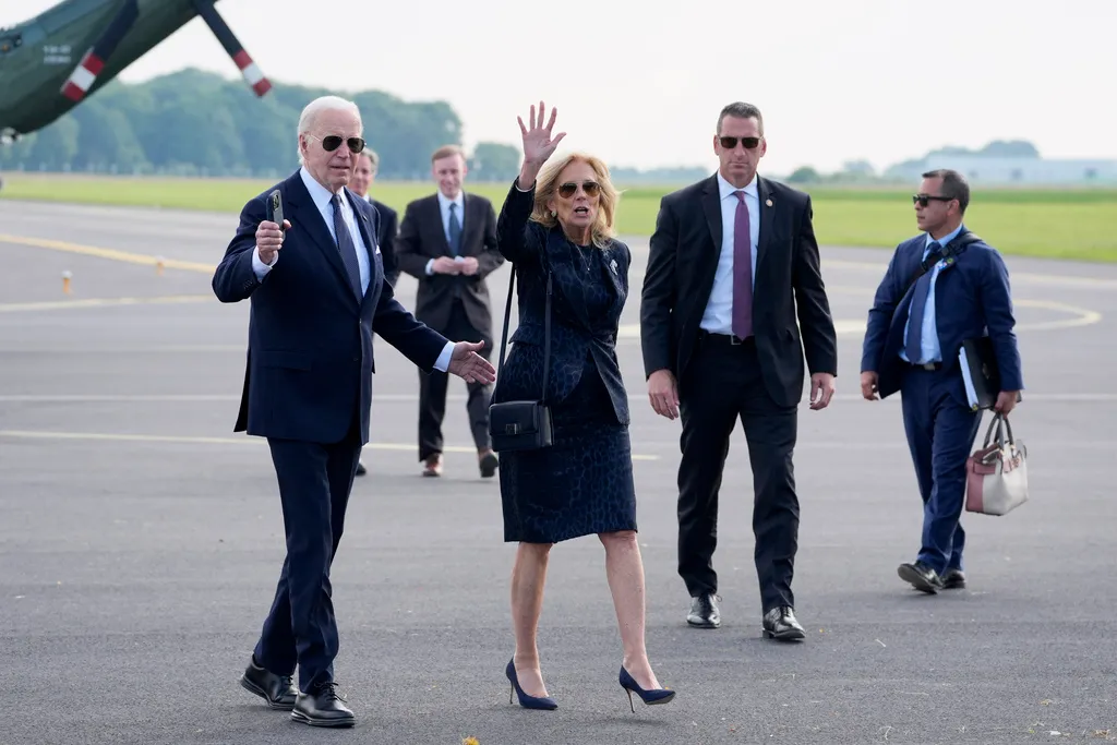 President Joe Biden and first lady Jill Biden walk to board Air Force One at the Caen-Carpiquet Airport.