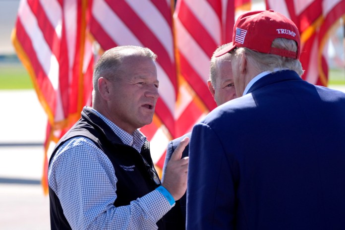 Rep. Troy Nehls, R-Texas, left, speaks with Republican presidential nominee former President Donald Trump after Trump spoke at a campaign event at Central Wisconsin Airport, Saturday, Sept. 7, 2024, in Mosinee, Wis.