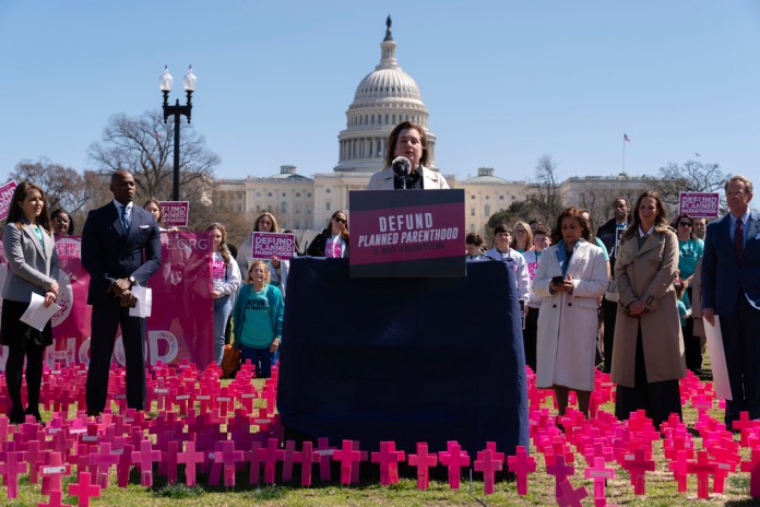 Marjorie Dannenfelser speaks at a podium outside the Capitol.