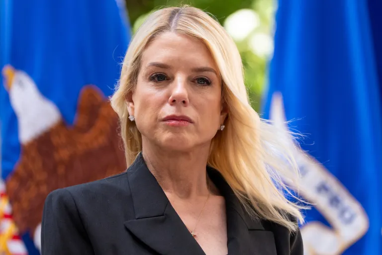 Attorney General Pam Bondi listens during a news conference.