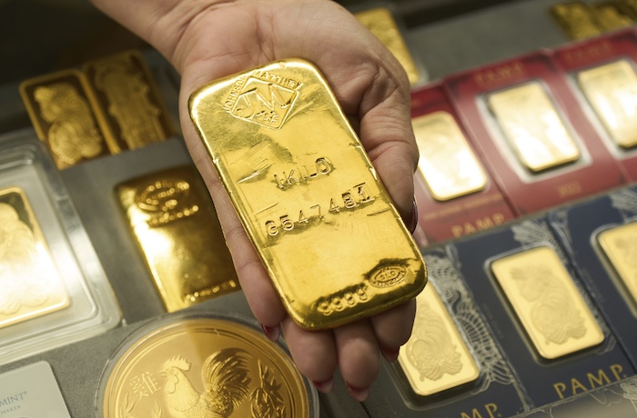 Sam Nguyen shows a gold bar at her shop in the St. Vincent Jewelry Center in the Jewelry District of Los Angeles, Wednesday, April 30, 2025. (AP Photo/Jae C. Hong)