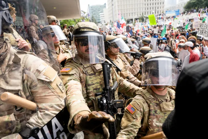 California National Guard and Marines hold back demonstrators at the Federal Building during a protest Saturday, June 14, 2025, in Los Angeles. 