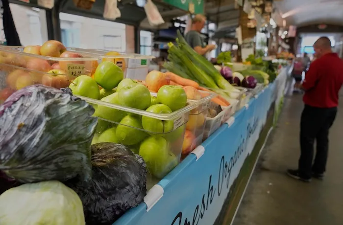 A customer purchases produce at West Side Market in Cleveland, Wednesday, July 16, 2025.