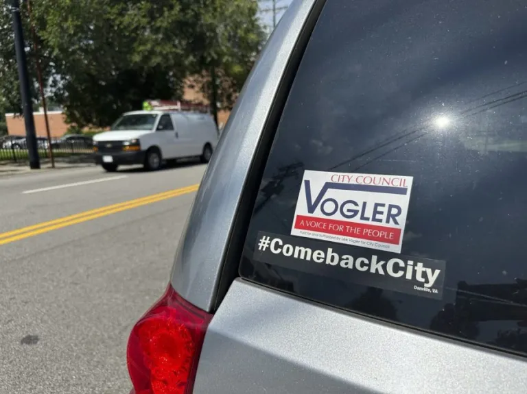 A bumper sticker for Lee Vogler is seen on the back of a car.