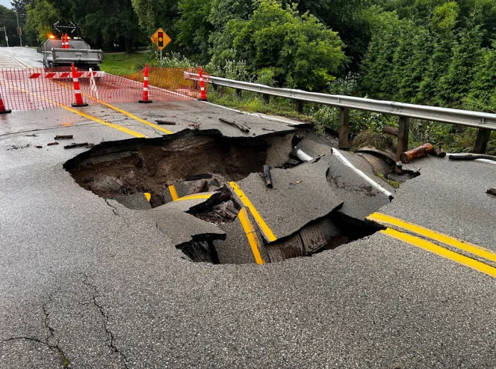 This image provided by CBS58 (WDJT) shows a damaged street as a result of flooding in the area in Milwaukee, Sunday, Aug. 10, 2025. 