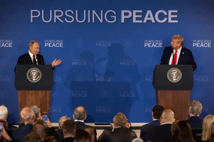 President Donald Trump listens to Russian President Vladimir Putin.