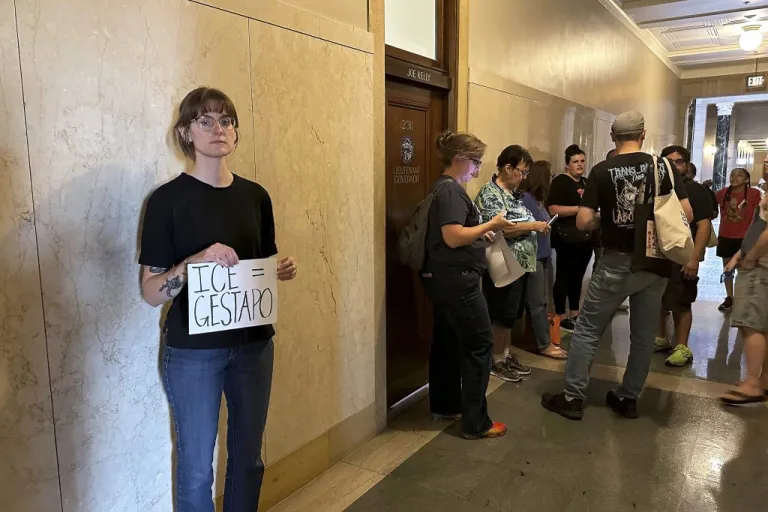 Emily Pietrzak holds a sign that reads 