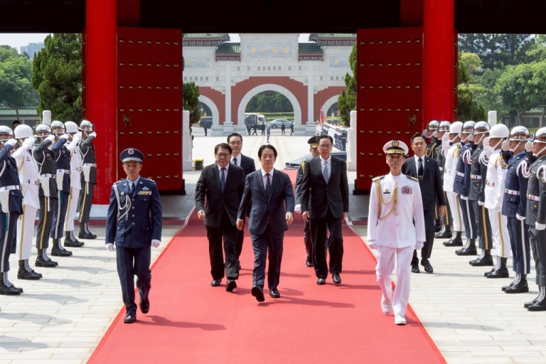 In this photo released by the Taiwan Presidential Office, Taiwan's President Lai Ching-te, center, arrives for a ceremony for honoring soldiers and officials during Taiwan's Arm Forces Day on Wednesday, Sep. 3, 2025 in Taipei, Taiwan.