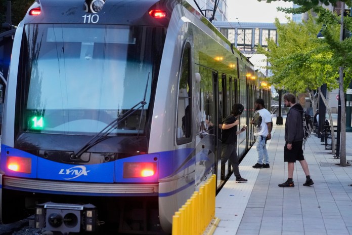 People enter and exit a Charlotte Area Transit System light rail on Monday, Sept. 8, 2025, in Charlotte, North Carolina. 