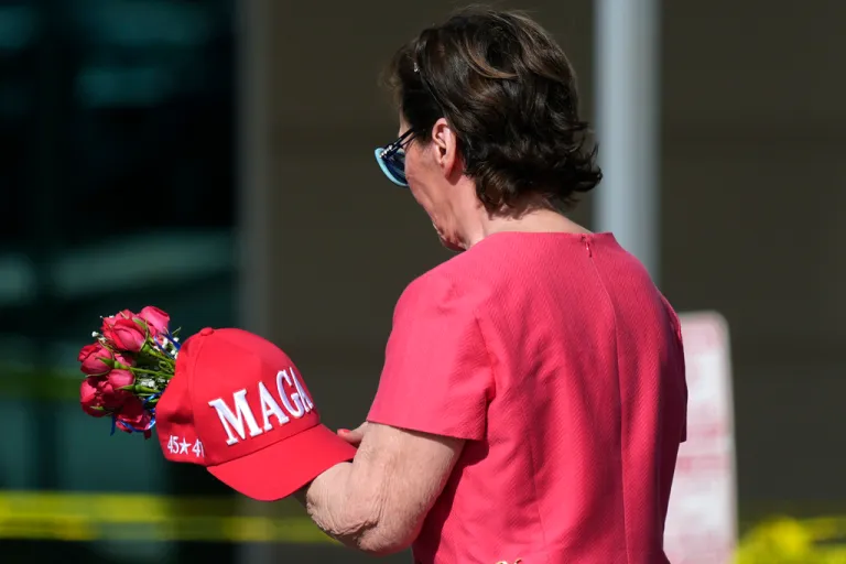 A well-wisher arrives at the national headquarters of Turning Point USA shown after the shooting death of Charlie Kirk, the co-founder and CEO of the organization, during a Utah college event, Wednesday, Sept. 10, 2025, in Phoenix.
