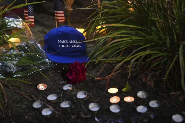 A Make America Great Again hat is placed at a growing vigil outside Timpanogos Regional Hospital after Charlie Kirk was shot and killed Wednesday, Sept. 10, 2025, in Orem, Utah. (AP Photo/Lindsey Wasson)