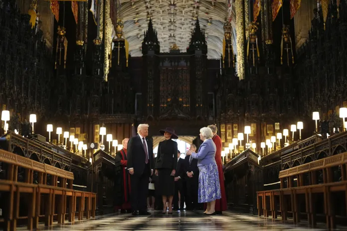 Chapter Clerk, Charlotte Manley, right, speaks to President Donald Trump and first lady Melania Trump during their visit to St George's Chapel at Windsor Castle, in Windsor, England, Wednesday Sept. 17, 2025.