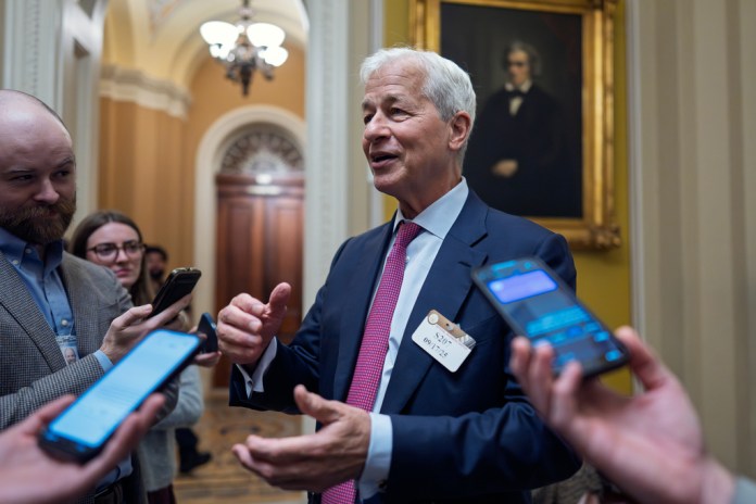Jamie Dimon, CEO and chairman of JPMorgan Chase, pauses to talk to reporters.