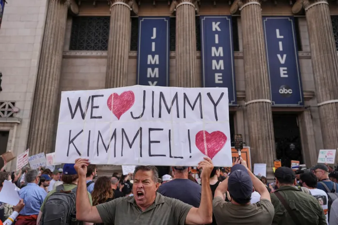 Oscar Villanueva holds a sign outside El Capitan Entertainment Centre, where the late-night show "Jimmy Kimmel Live!" is staged, Thursday, Sept. 18, 2025, in Los Angeles. 
