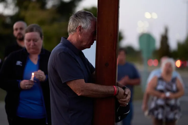 Dan Beazley, of Northville, prays during a vigil held at the Henry Ford Genesys Regional Hospital for the Sunday morning shooting at The Church of Jesus Christ of Latter-day Saints in Grand Blanc Township, Michigan.