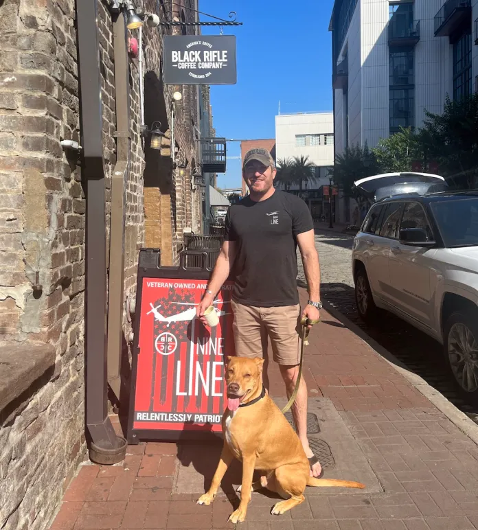 Nine Line Apparel CEO Tyler Merritt stands outside his River Street store that is shared with Black Rifle Coffee Company in Savannah, Georgia.