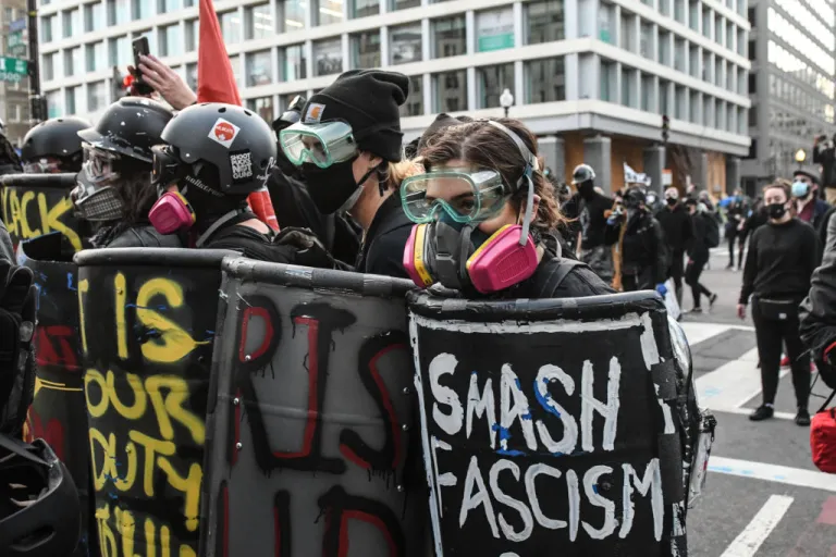 Members of Antifa hold shields during a protest at Black Lives Matter Plaza on December 12, 2020 in Washington, DC. Thousands of protesters who refuse to accept that President-elect Joe Biden won the election are rallying ahead of the electoral college vote to make Trump's 306-to-232 loss official. (Photo by Stephanie Keith/Getty Images)
