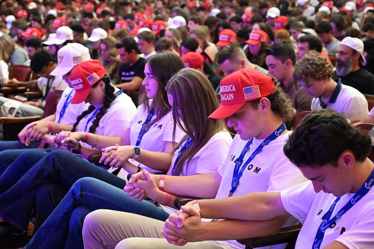 Attendees pray during an 