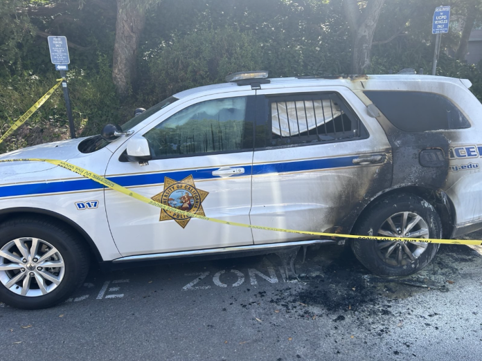 A photograph of the torched University of California Police Department cop patrol car posted to Abolition Media, an anarchist blog.
