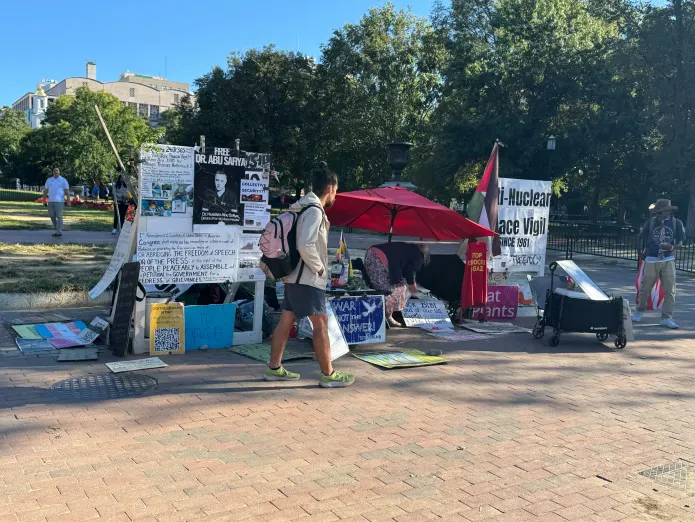 Neal Cousins and Shell maintain the peace vigil opposite the White House.