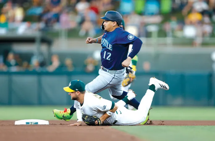 Josh Naylor of the Seattle Mariners steals second base as Max Schuemann of the Athletics is unable to field a throw in the top of the fourth inning on July 28 in Sacramento, California. (Lachlan Cunningham/Getty Images)