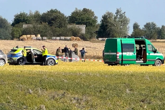 Police and military police secure parts of a damaged UAV shot down by Polish authorities.