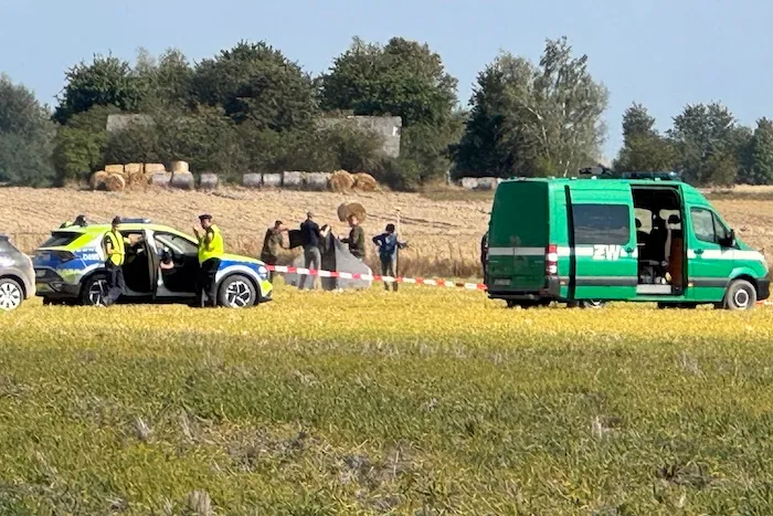 Police and Military Police secure parts of a damaged UAV shot down by Polish authorities at a site in Wohyn, Poland, Wednesday, Sept. 10, 2025.(AP Photo/Rafal Niedzielski)