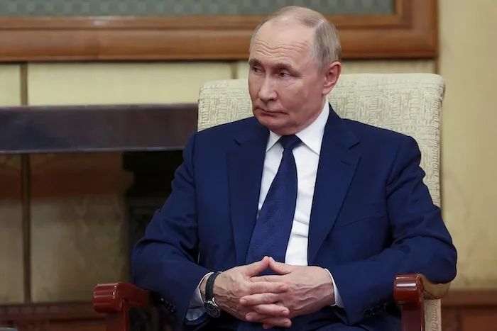 Russian President Vladimir Putin listens to Serbian President Aleksandar Vucic during their meeting at Diaoyutai State Guesthouse in Beijing, China, Tuesday, Sept. 2, 2025.