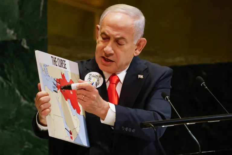 Israeli Prime Minister Benjamin Netanyahu holds a map while speaking at the 80th session of the United Nations General Assembly.