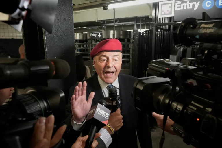 Curtis Sliwa speaks to reporters. Cameras ad microphones are present