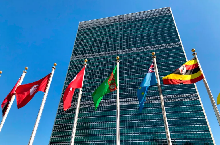 FILE - In this Sept. 28, 2019 file photo, flags fly outside the United Nations headquarters during the 74th session of the United Nations General Assembly. Secretary-General Antonio Guterres says the United Nations is facing its “worst cash crisis” in nearly a decade because 64 of its 193 members have not paid their annual dues, including the United States, which is the U.N.’s largest contributor. (AP Photo/Jennifer Peltz, File)