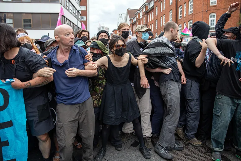 August 2, 2025, London, Islington, United Kingdom: Members of ANTIFA hold their hands in a line during the demonstration. Residents protested under the banner ‚??Thistle Barbican needs to go locals say no‚??. Right-wing groups and ‚??Stand up to Racism‚?? held counter-protests outside the hotel, with police ensuring separation. The demonstration was in response to reported crimes by hotel residents and ongoing tensions over migrant accommodation. Early in the afternoon, a group identified as ANTIFA arrived and remained in the centre of the road, prompting police to first move them to the designated protest area and subsequently use force to arrest individuals who did not comply. (Credit Image: © James Willoughby/SOPA Images via ZUMA Press Wire) (Newscom TagID: zumaamericasfortyeight704121.jpg) [Photo via Newscom]