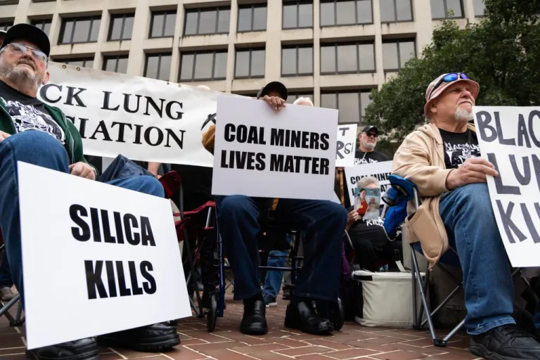 Coal miners protest in front of the Labor Department.
