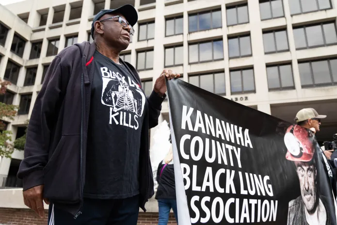 Roosevelt Neal, a former West Virginia miner of 28 years, protests in front of the Labor Department.