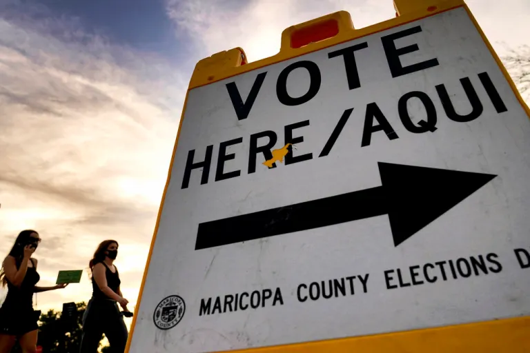 Voters deliver their ballots to a polling station