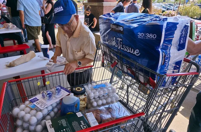 A customer checks his shopping receipts.