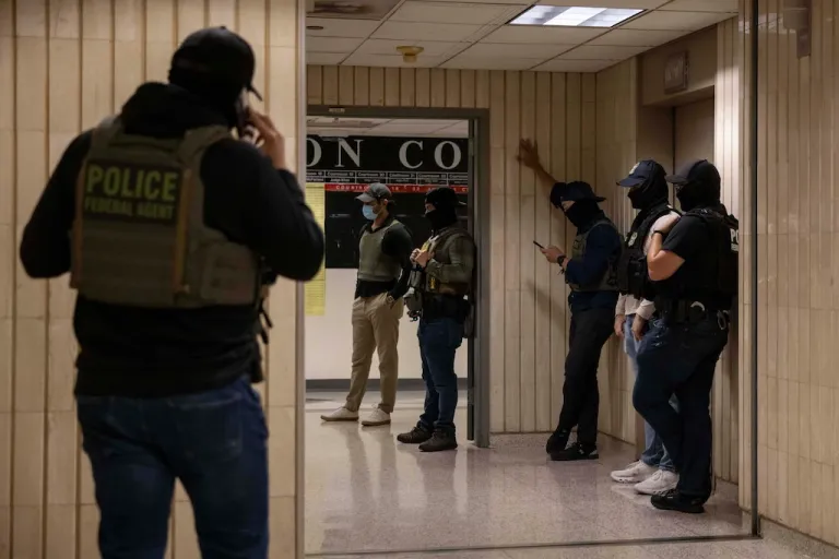 Federal agents walk around at an immigration court.