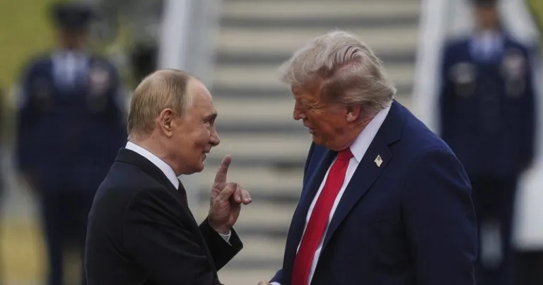 President Donald Trump greets Russia's President Vladimir Putin on the tarmac at Joint Base Elmendorf-Richardson in Anchorage, Alaska, Aug. 15, 2025. (AP Photo/Julia Demaree Nikhinson)