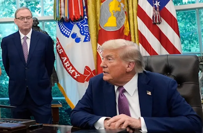 President Donald Trump speaks in the Oval Office of the White House, Friday, Sept. 5, 2025, in Washington, as U.S. Chief of Protocol Monica Crowley and Director of the National Economic Council Kevin Hassett listen. (AP Photo/Alex Brandon)