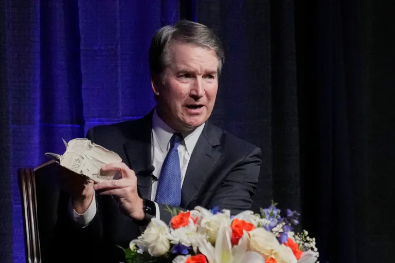 Justice Brett Kavanaugh holds his personal pocket constitution as he speaks at The Ken Starr Lecture at McLennan Community College, Thursday, Sept. 11, 2025, in Waco, Texas.