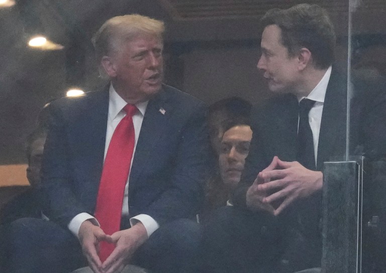 President Donald Trump and Elon Musk talk during a memorial for the late conservative commentator Charlie Kirk.