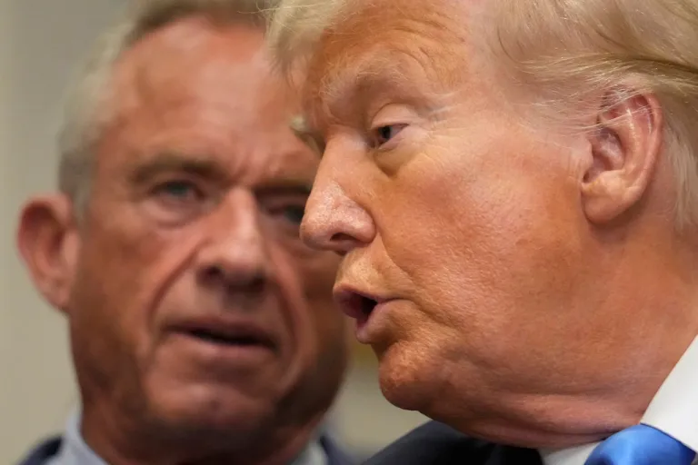 President Donald Trump speaks in the Roosevelt Room of the White House, Monday, Sept. 22, 2025, in Washington, as Health and Human Services Secretary Robert F. Kennedy Jr. listens. (AP Photo/Mark Schiefelbein)