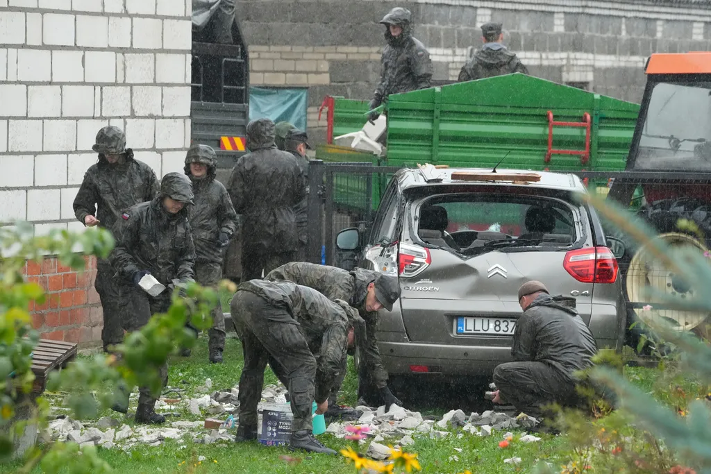 Territorial defense officers clear debris from a house near Lublin, Poland, after Russian drones violated Polish airspace Thursday, Sept. 11, 2025. 