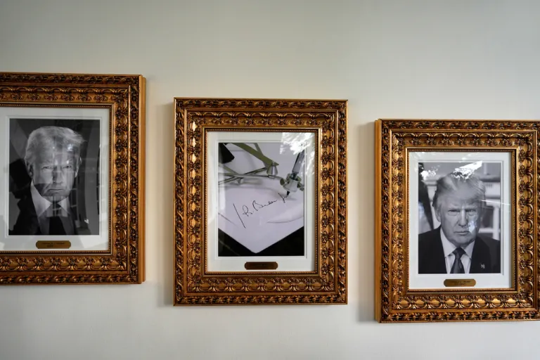 Framed images of President Donald Trump and former President Joe Biden's autopen signature, center, appear on the Presidential Walk of Fame on the colonnade of the White House, Friday, Sept. 26, 2025, in Washington.