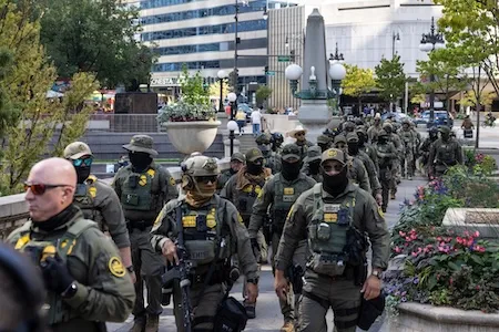 Federal agents from U.S. Immigration and Customs Enforcement and U.S. Customs and Border Protection walk along West Wacker Drive in the Loop, Sunday, Sept. 28, 2025, in Chicago. (Ashlee Rezin/Chicago Sun-Times via AP)