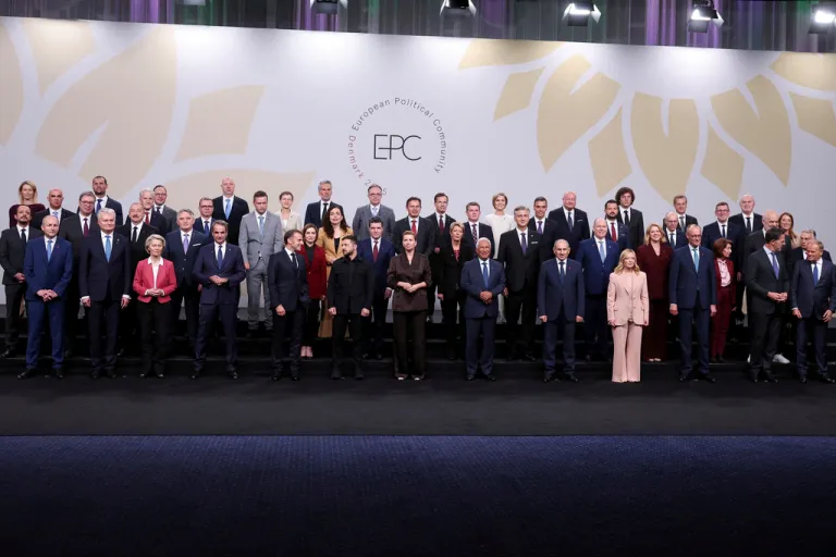 Heads of state pose for a family photo.