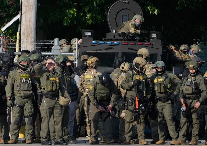 Greg Bovino, the chief patrol agent for the U.S. Border Patrol El Centro sector, center, stands with federal immigration agents near an Immigration and Customs Enforcement facility in Broadview, Ill., Friday, Oct. 3, 2025. (AP Photo/Erin Hooley)