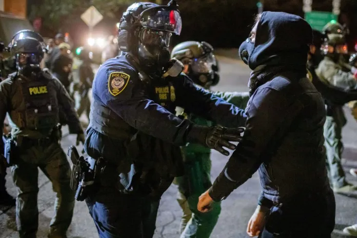 Protesters confront federal law enforcement officers outside a U.S. Immigration and Customs Enforcement facility in Portland, Ore., Monday, Oct. 6, 2025.